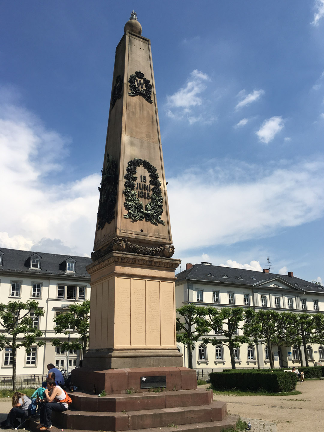 Inscription on the pedestal of the Waterloo-Obelisk: THE MEMORIES IN THE BATTLE OF WATERLOO FALLEN NASSAUER AM 18 JUNI 1815 Luisenplatz